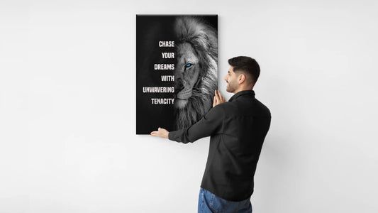 Muraspire team member guy hanging motivational canvas with lion mindset on a wall.